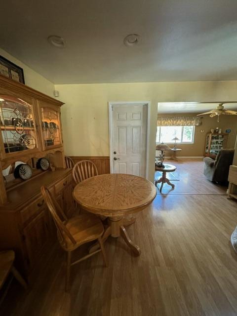 37023 Park Ave, Burney, CA 96013 - dining space featuring a ceiling fan, wood finished floors, and wainscoting