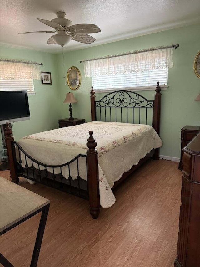 37023 Park Ave, Burney, CA 96013 - bedroom featuring multiple windows, wood finished floors, and ceiling fan