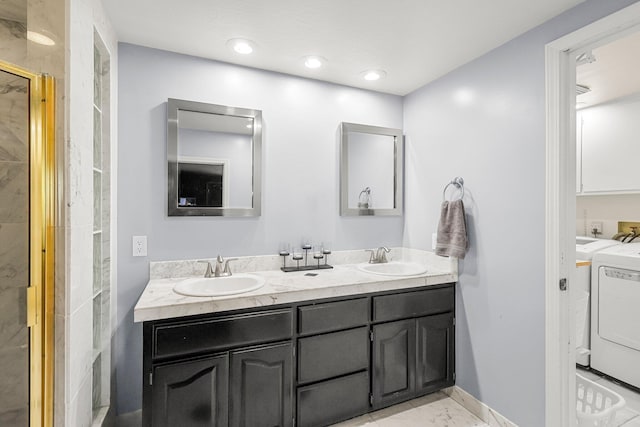 409 Ridgecrest Trl, Redding, CA 96003 - full bathroom with washer and dryer, double vanity, marble finish floors, and a shower stall