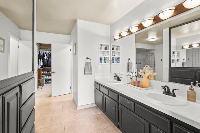 409 Ridgecrest Trl, Redding, CA 96003 - full bathroom featuring double vanity, tile patterned floors, a walk in closet, and a tile shower