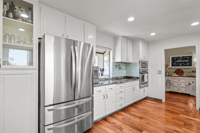 409 Ridgecrest Trl, Redding, CA 96003 - kitchen featuring appliances with stainless steel finishes, white cabinetry, light wood-style floors, backsplash, and recessed lighting