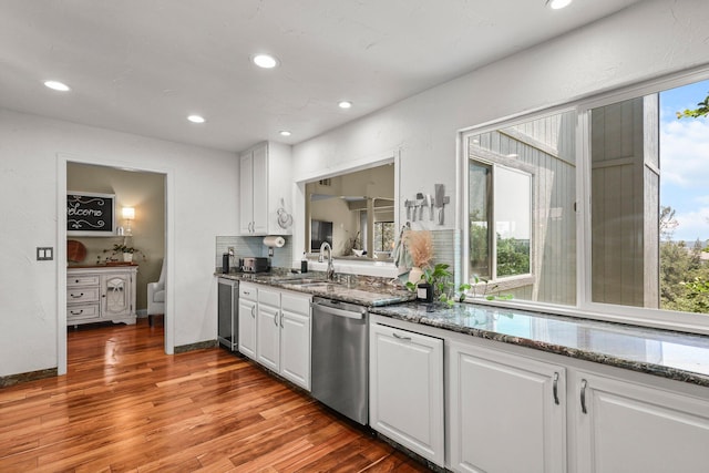 409 Ridgecrest Trl, Redding, CA 96003 - kitchen featuring stainless steel dishwasher, recessed lighting, white cabinets, wood finished floors, and dark stone countertops
