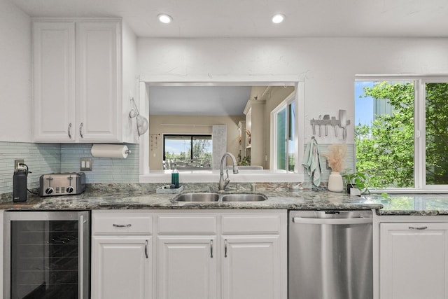 409 Ridgecrest Trl, Redding, CA 96003 - kitchen featuring stainless steel dishwasher, wine cooler, white cabinetry, decorative backsplash, and dark stone countertops