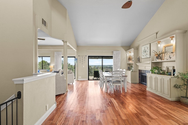 409 Ridgecrest Trl, Redding, CA 96003 - dining room with hardwood / wood-style floors, high vaulted ceiling, a fireplace, and a ceiling fan