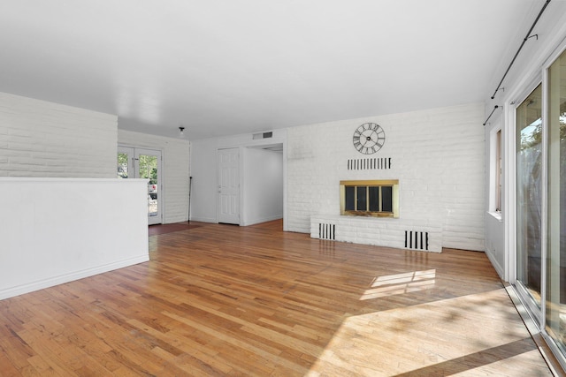 2955 Shasta St, Redding, CA 96001 - unfurnished living room with wood finished floors and a brick fireplace