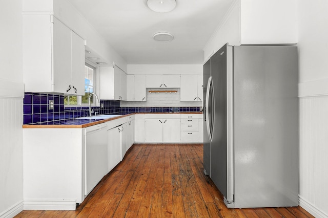 2955 Shasta St, Redding, CA 96001 - kitchen with stainless steel fridge with ice dispenser, white dishwasher, tasteful backsplash, and white cabinets