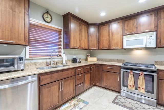 3274 Quartz Hill Rd, Redding, CA 96003 - kitchen featuring stainless steel appliances, a sink, light tile patterned floors, light stone countertops, and recessed lighting