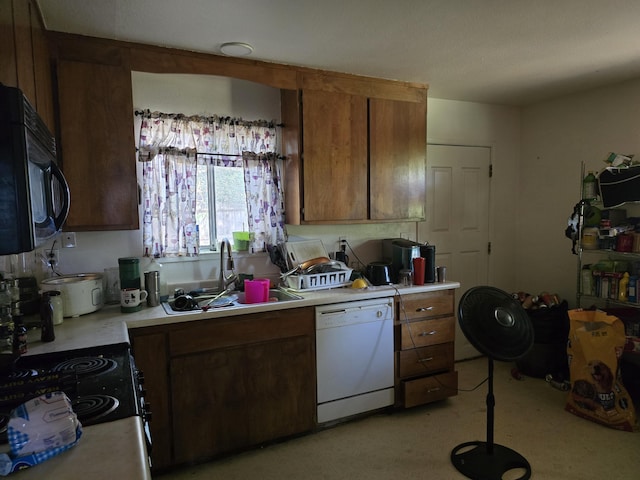 1591 Canby Rd, Redding, CA 96002 - kitchen featuring dishwasher, black microwave, light countertops, a sink, and brown cabinets