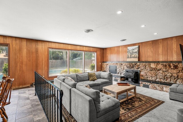 3371 Bardick Rd, Anderson, CA 96007 - living area featuring wooden walls, a wood stove, recessed lighting, and stone finish flooring