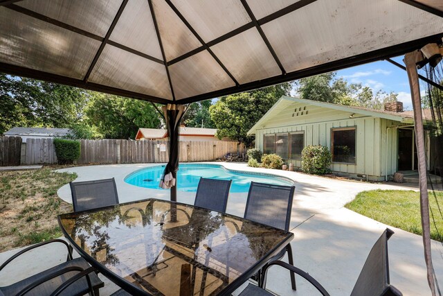 3371 Bardick Rd, Anderson, CA 96007 - view of swimming pool featuring outdoor dining area, a fenced backyard, a patio area, and an outbuilding