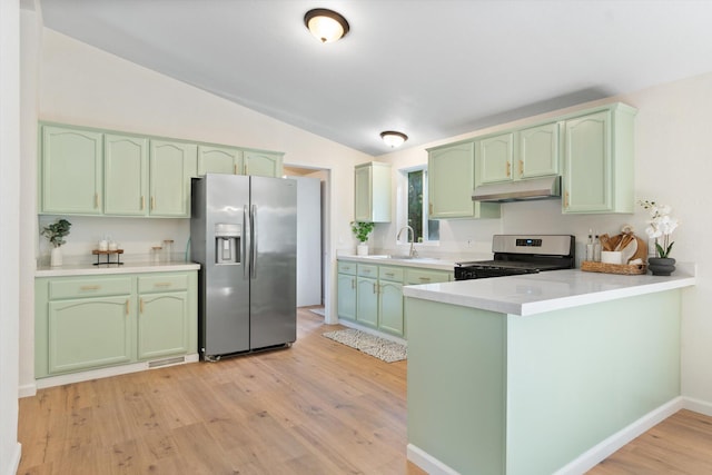 7727 Pegnan Rd, Shingletown, CA 96088 - kitchen with green cabinetry, appliances with stainless steel finishes, under cabinet range hood, a sink, and vaulted ceiling