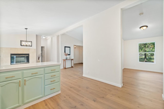 7727 Pegnan Rd, Shingletown, CA 96088 - kitchen featuring green cabinets, lofted ceiling, light countertops, a chandelier, and light wood-style floors