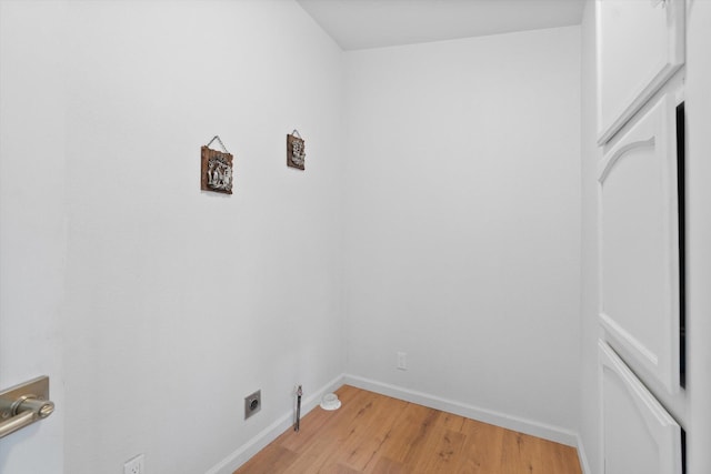 7727 Pegnan Rd, Shingletown, CA 96088 - laundry area featuring electric dryer hookup, light wood-type flooring, and baseboards