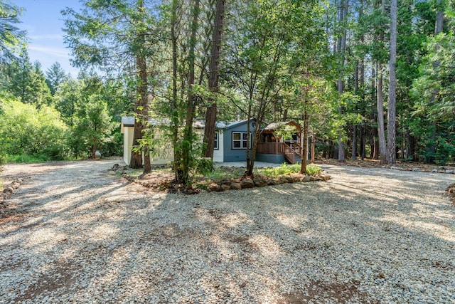 7727 Pegnan Rd, Shingletown, CA 96088 - view of front of property with gravel driveway and a view of trees