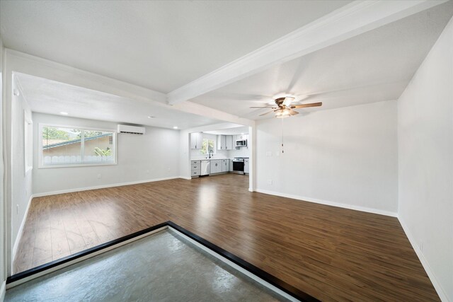 1949 Montana Ave, Shasta Lake, CA 96019 - unfurnished living room featuring wood finished floors, an AC wall unit, baseboards, ceiling fan, and beam ceiling