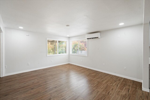 1949 Montana Ave, Shasta Lake, CA 96019 - empty room with a wall mounted AC, baseboards, wood finished floors, and recessed lighting