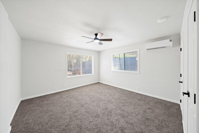 1949 Montana Ave, Shasta Lake, CA 96019 - unfurnished room with a wall mounted air conditioner, ceiling fan, carpet flooring, and baseboards