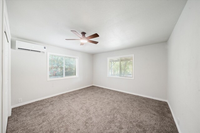 1949 Montana Ave, Shasta Lake, CA 96019 - empty room with an AC wall unit, carpet floors, and healthy amount of natural light