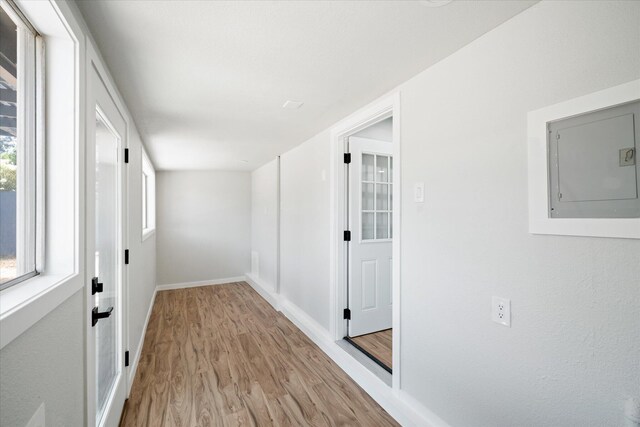 1949 Montana Ave, Shasta Lake, CA 96019 - hallway featuring electric panel, light wood-style floors, and baseboards