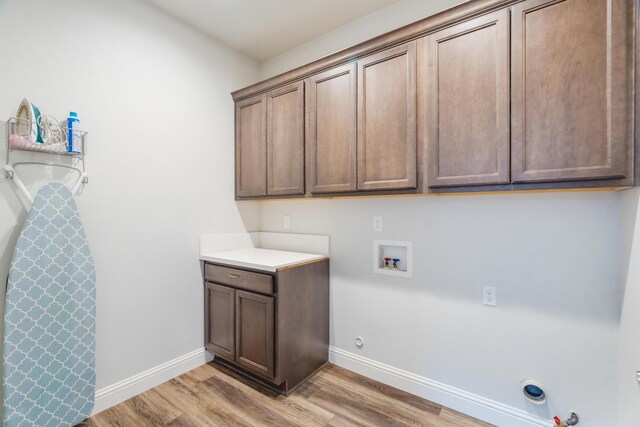 4537 Risstay Way, Shasta Lake, CA 96019 - laundry area with hookup for a gas dryer, light wood finished floors, hookup for a washing machine, and cabinet space
