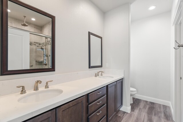 4537 Risstay Way, Shasta Lake, CA 96019 - bathroom featuring double vanity, a tile shower, wood finished floors, and recessed lighting