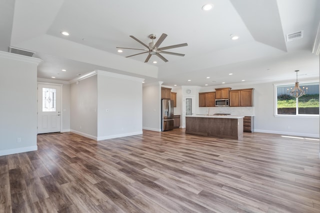 4537 Risstay Way, Shasta Lake, CA 96019 - unfurnished living room with a tray ceiling, ceiling fan, recessed lighting, ornamental molding, and wood finished floors