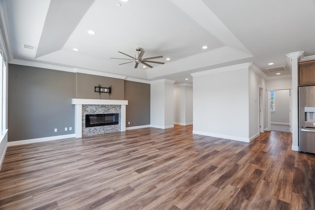 4537 Risstay Way, Shasta Lake, CA 96019 - unfurnished living room with a raised ceiling, a ceiling fan, recessed lighting, wood finished floors, and a glass covered fireplace