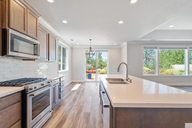 4537 Risstay Way, Shasta Lake, CA 96019 - kitchen with stainless steel appliances, light wood finished floors, recessed lighting, light countertops, and crown molding