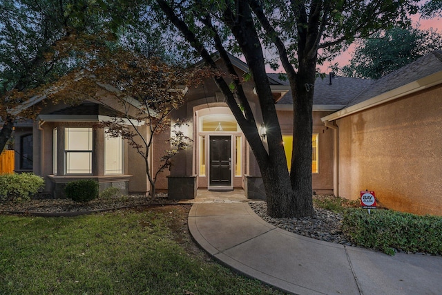4230 Brittany Dr, Redding, CA 96002 - exterior entry at dusk featuring stucco siding