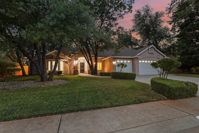 4230 Brittany Dr, Redding, CA 96002 - view of front of home featuring driveway, a yard, an attached garage, and stucco siding