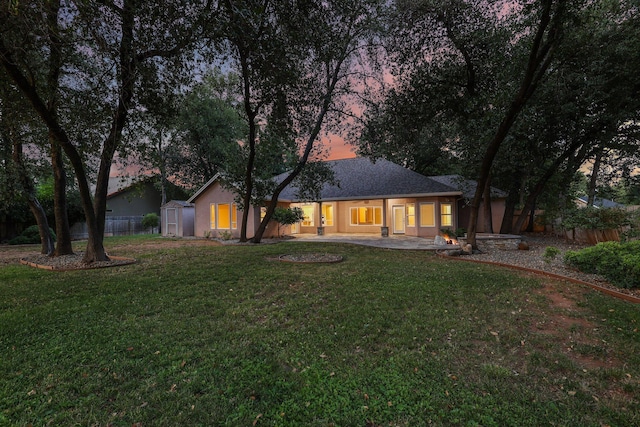 4230 Brittany Dr, Redding, CA 96002 - back of property at dusk with stucco siding
