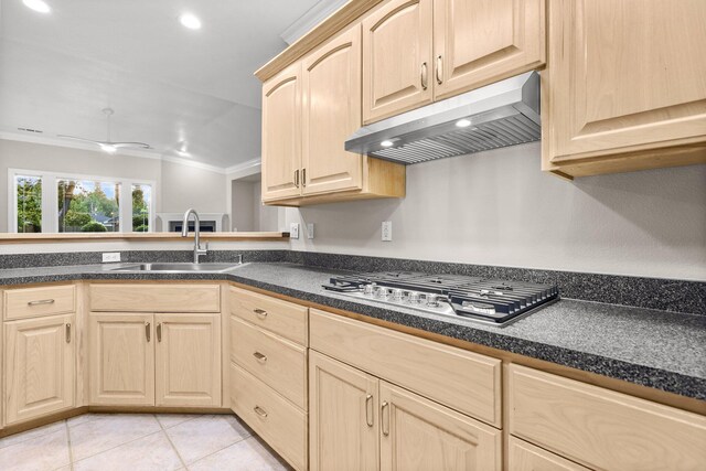 4230 Brittany Dr, Redding, CA 96002 - kitchen with under cabinet range hood, light brown cabinetry, stainless steel gas cooktop, dark countertops, and recessed lighting