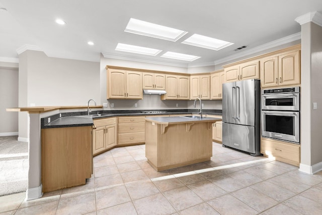 4230 Brittany Dr, Redding, CA 96002 - kitchen with stainless steel appliances, light brown cabinetry, ornamental molding, a breakfast bar area, and under cabinet range hood