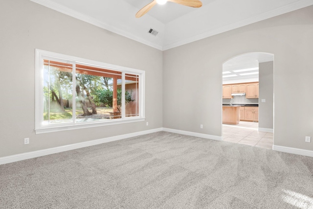 4230 Brittany Dr, Redding, CA 96002 - spare room featuring a ceiling fan, light colored carpet, crown molding, and arched walkways