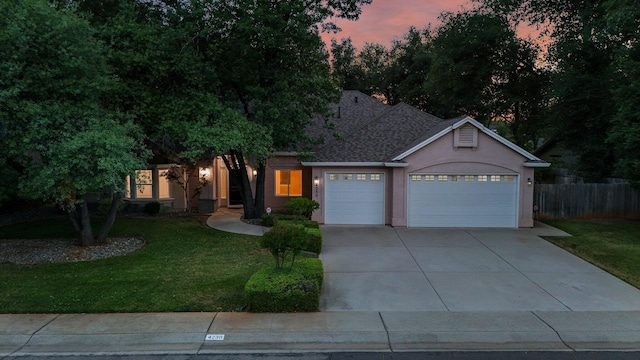 4230 Brittany Dr, Redding, CA 96002 - view of front of home featuring a garage, concrete driveway, stucco siding, and roof with shingles