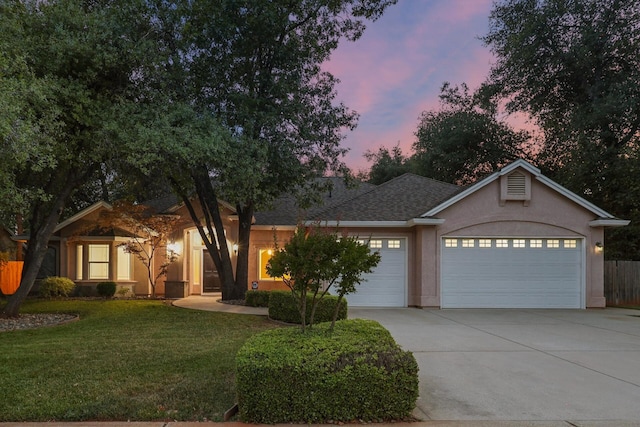 4230 Brittany Dr, Redding, CA 96002 - ranch-style home with concrete driveway, a garage, stucco siding, and a shingled roof