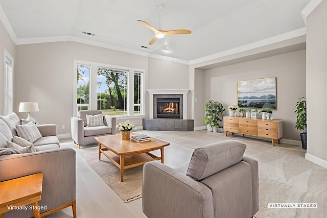 4230 Brittany Dr, Redding, CA 96002 - living room featuring ceiling fan, ornamental molding, a tiled fireplace, and light wood finished floors