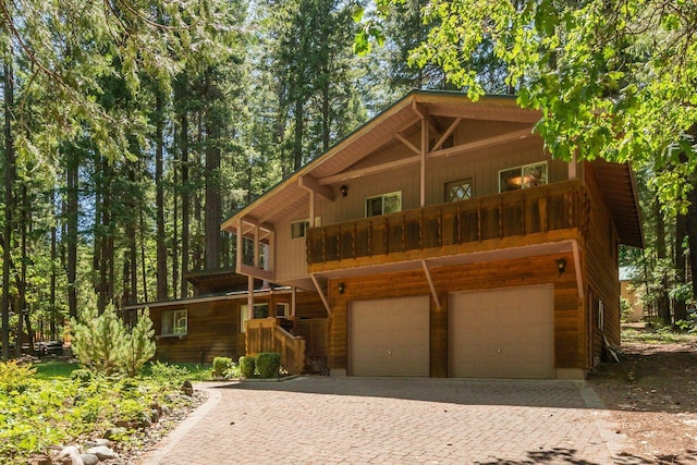 131 Northwoods Ests, Trinity Center, CA 96091 - rustic home featuring a garage, decorative driveway, and a balcony