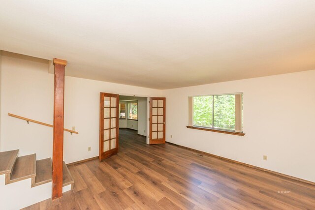 131 Northwoods Ests, Trinity Center, CA 96091 - empty room featuring wood finished floors, french doors, and stairway