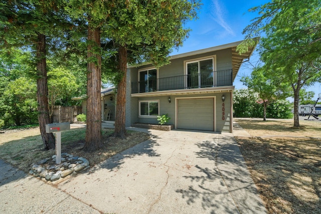 4050 Oro Ct, Redding, CA 96001 - view of front property with a balcony, concrete driveway, and a garage
