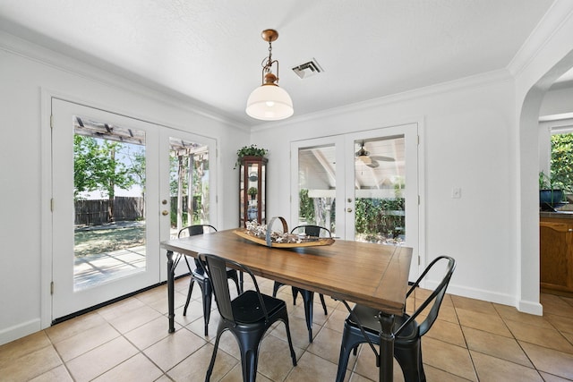 4050 Oro Ct, Redding, CA 96001 - dining space featuring french doors, light tile patterned flooring, ornamental molding, and arched walkways