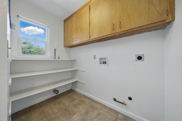 4050 Oro Ct, Redding, CA 96001 - laundry area featuring hookup for a gas dryer, hookup for an electric dryer, washer hookup, cabinet space, and tile patterned flooring