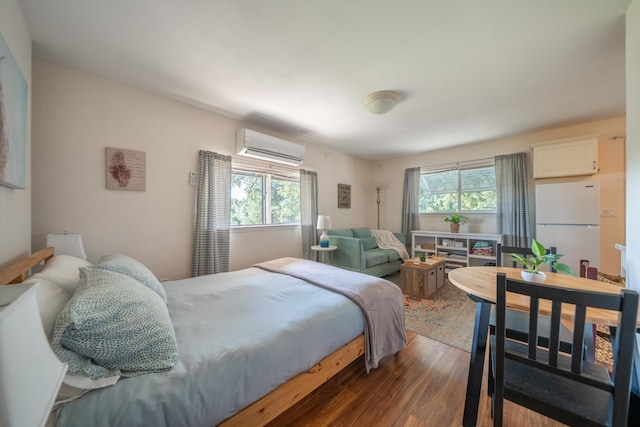 9733 Hidden Ln, Palo Cedro, CA 96073 - bedroom featuring freestanding refrigerator, wood finished floors, a wall mounted AC, and multiple windows