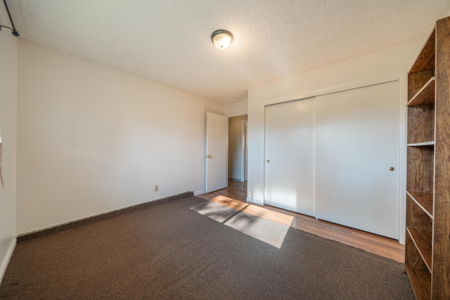 9733 Hidden Ln, Palo Cedro, CA 96073 - unfurnished bedroom with carpet, a closet, and a textured ceiling