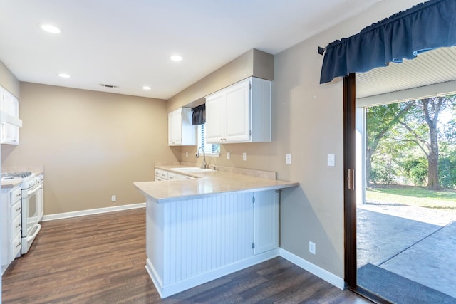830 Redwood Blvd, Redding, CA 96003 - kitchen featuring white gas stove, dark wood finished floors, light countertops, white cabinetry, and a peninsula