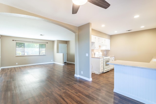 830 Redwood Blvd, Redding, CA 96003 - kitchen with white range with gas cooktop, light countertops, a ceiling fan, arched walkways, and white cabinets