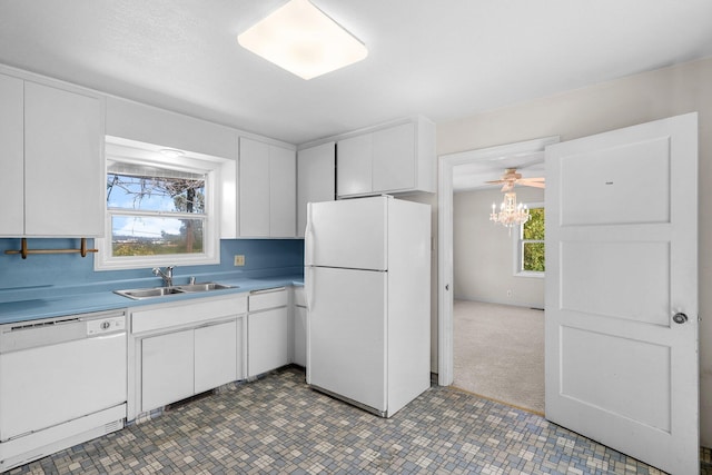 2040 Sonoma St, Redding, CA 96001 - kitchen with white appliances, white cabinets, and light countertops