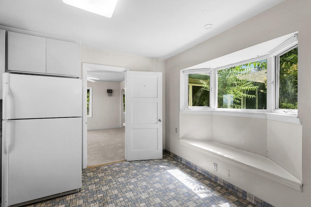 2040 Sonoma St, Redding, CA 96001 - interior space featuring freestanding refrigerator and white cabinetry
