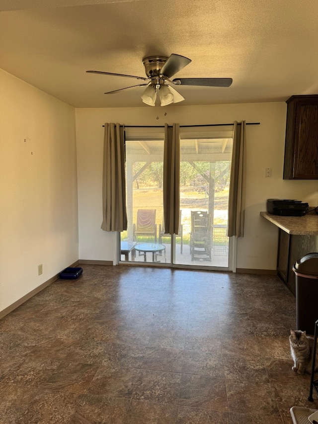 2580 Old Alturas Rd, Redding, CA 96003 - unfurnished living room with baseboards and a ceiling fan