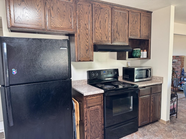 2580 Old Alturas Rd, Redding, CA 96003 - kitchen with black appliances, under cabinet range hood, light countertops, and dark brown cabinetry